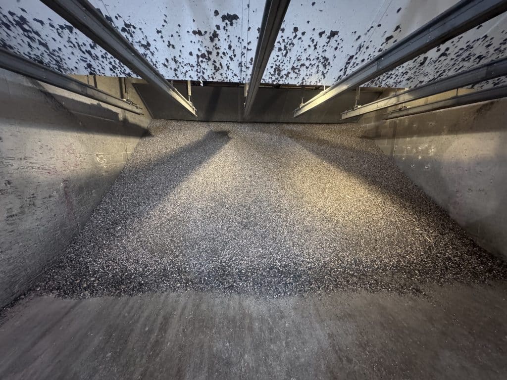 Interior view of a full rubber berm trap filled with lead shot and bullet fragments at a gun range
